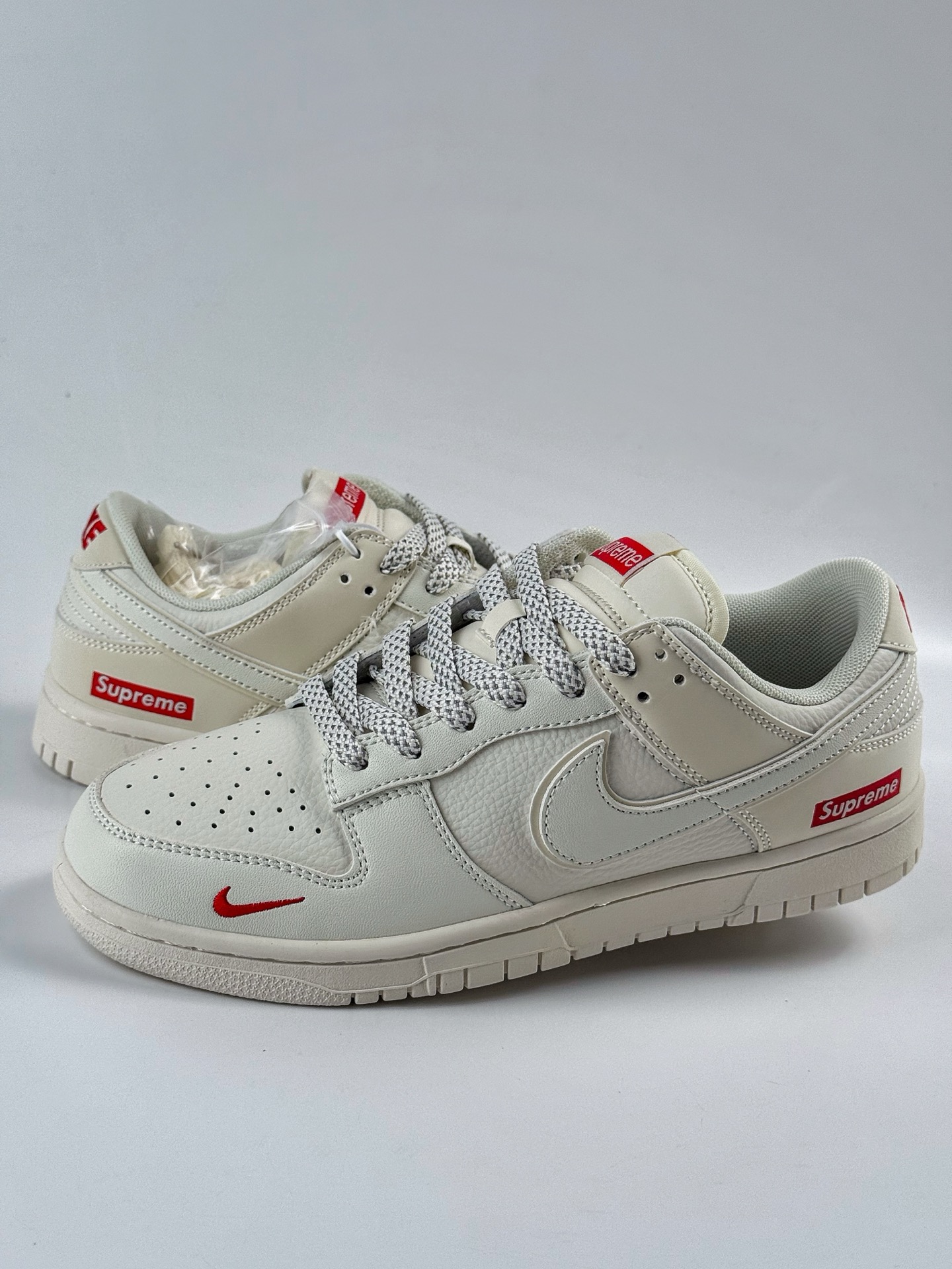 Nike SB Dunk Low x Supreme White and Red Swoosh Star